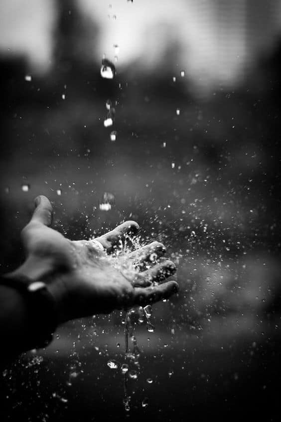 Big Ditch Dam Building Company a man reaching out to catch raindrops