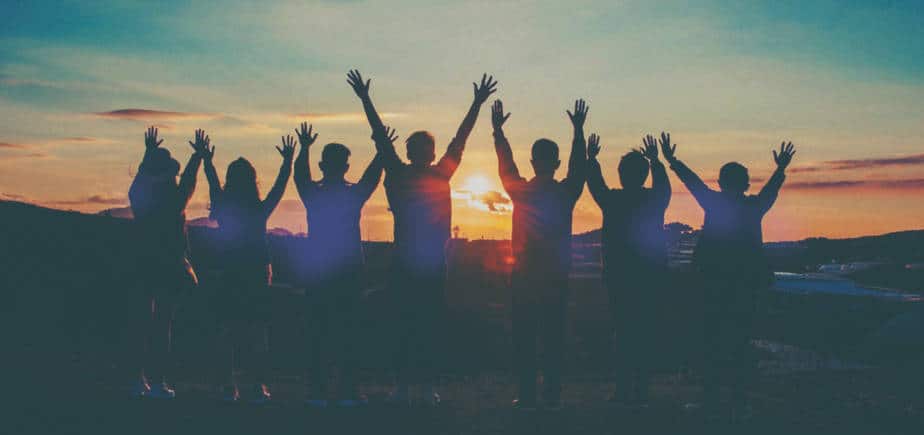 Big Ditch Dam Building Co. Group of people jumping for joy around a dam