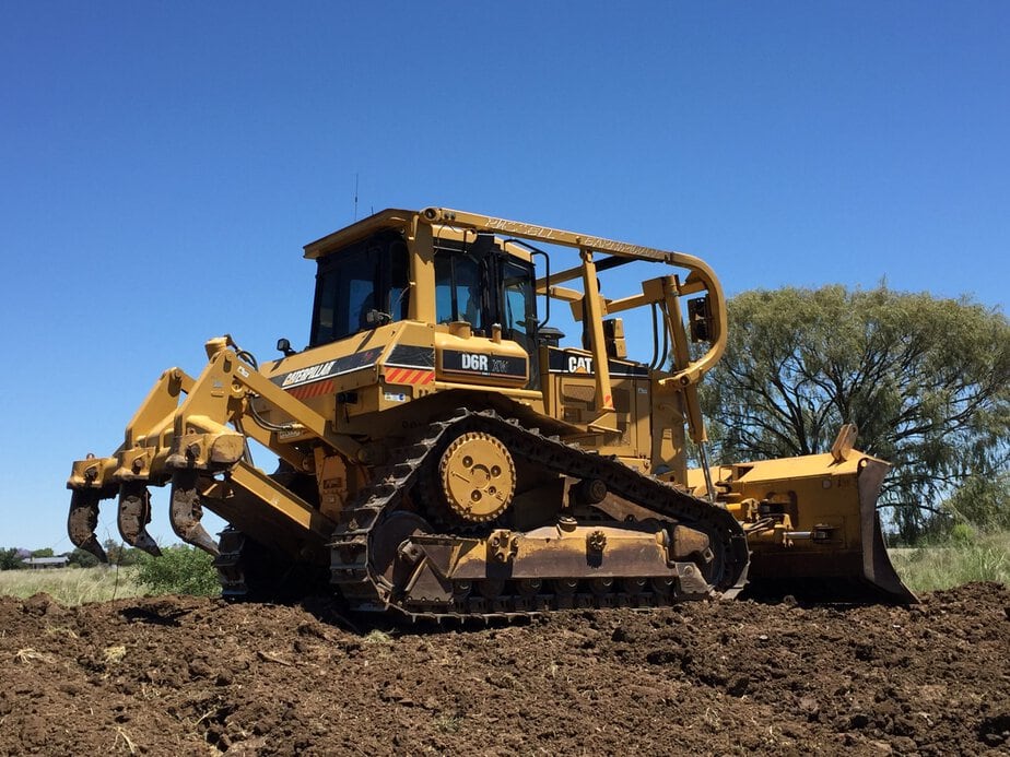 Bulldozer used by Big Ditch Dam Building Company for dam construction projects.