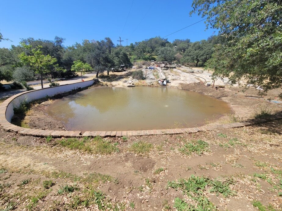 Dam construction by Big Ditch Dam Building Company for water management.