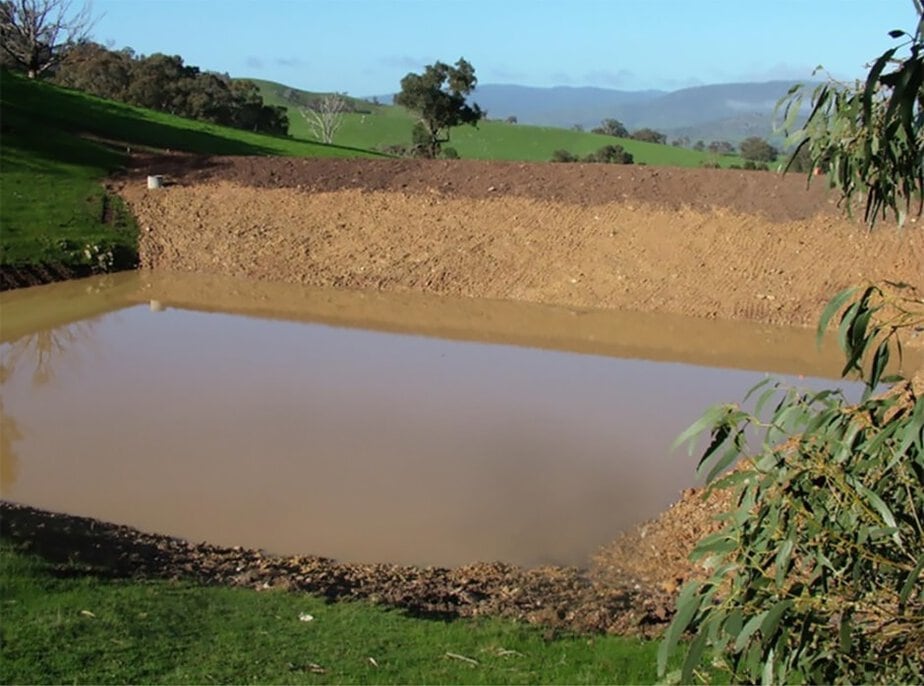 Dam built by Big Ditch Dam Building Company for water storage and flood control.
