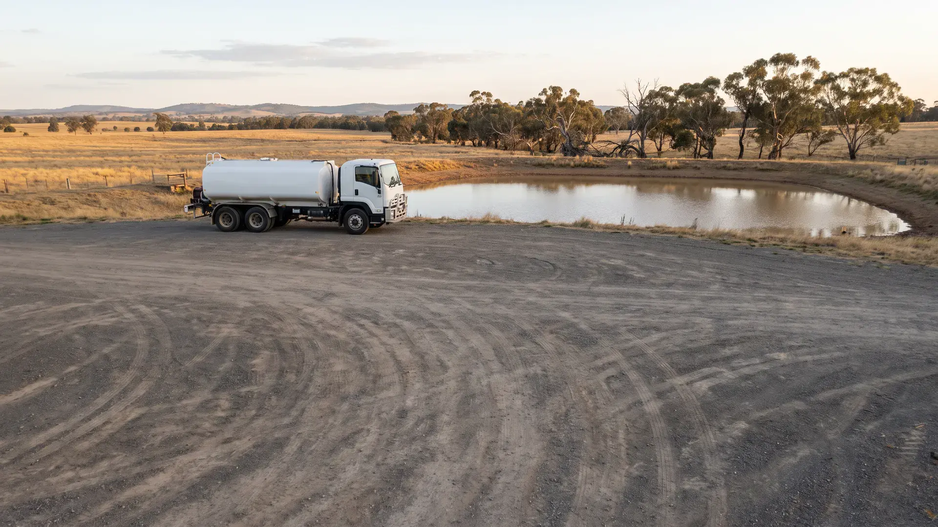 Water tanker beside Australian storage illustrating plans to sell water from farm dam supplies