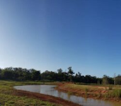 Earth dam construction by Big Ditch Dam Building Company for water management and flood control.