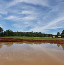 Heavy construction site with dam and water retention system, Big Ditch Dam Building Company, expert in dam construction.