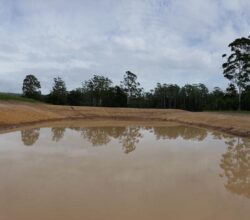 Heavy-duty dam construction by Big Ditch Dam Building Company in progress.