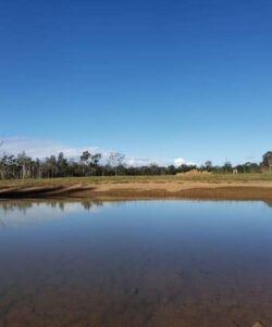 Stone dam construction site by Big Ditch Dam Building Company, expert in dam and water management solutions.