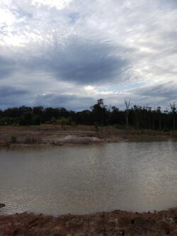 Heavy-duty dam construction site with water reservoir by Big Ditch Dam Building Company, ensuring durable water management solutions.