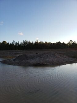 Heavy dam construction work by Big Ditch Dam Building Company in progress, specializing in erosion control and water management solutions.
