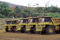 Construction dump trucks at Big Ditch Dam Building site, heavy earthmoving equipment.