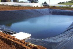 Heavy-duty dam construction with waterproof lining for water retention and storage.