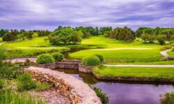 Lush golf course with water features and landscaping, showcasing professional dam building and water management.
